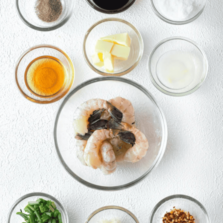 Ingredients for air fryer honey garlic shrimp: raw shrimp, honey, soy sauce, butter, garlic, lime, and seasonings