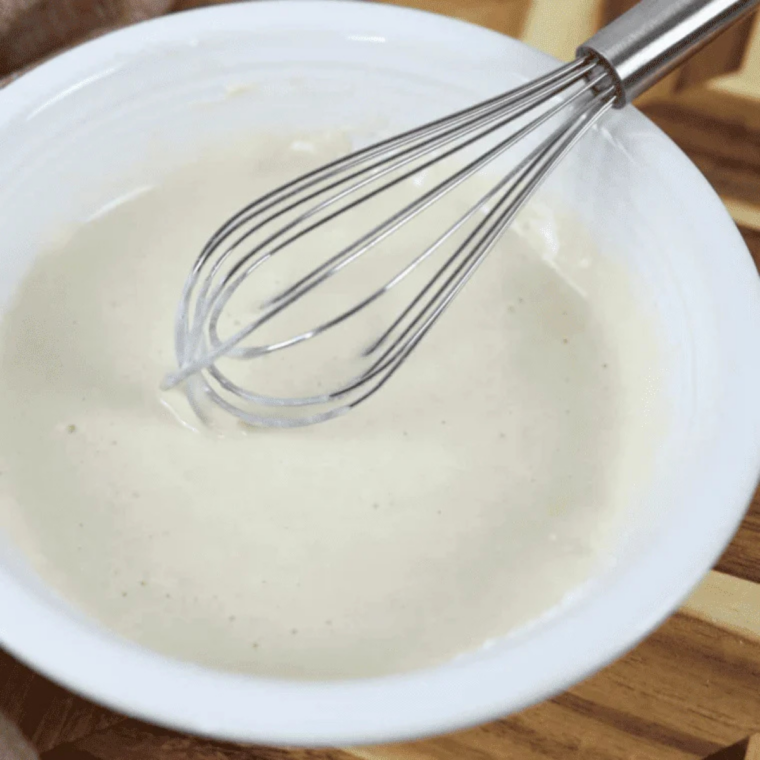 Flour, sugar, baking powder and milk whisked together into a smooth batter in a small glass bowl