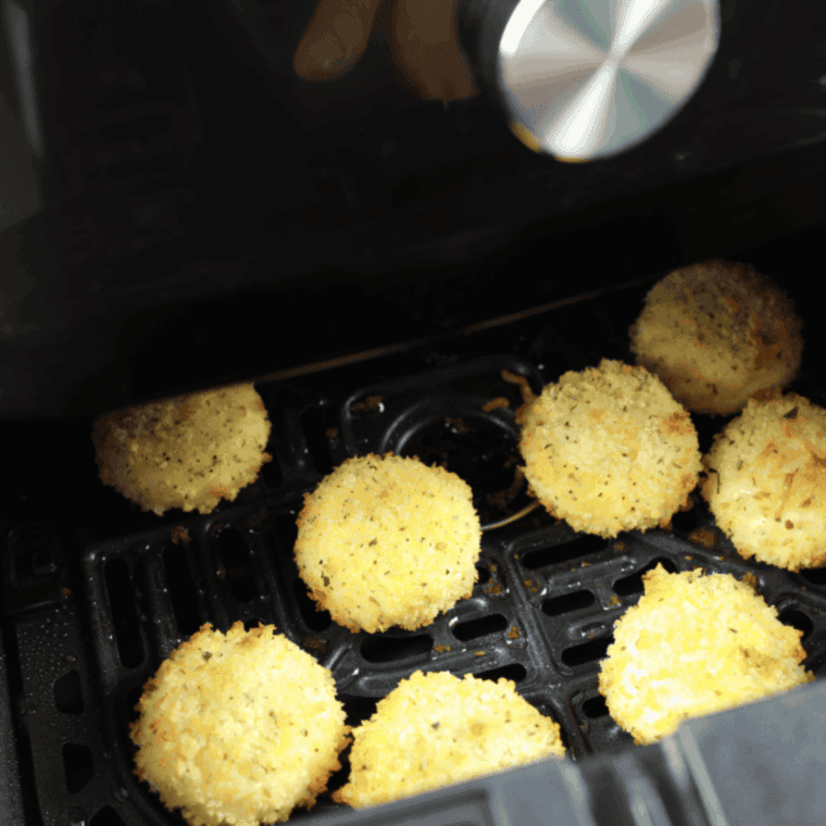 Golden brown crispy air fryer Babybel cheese fresh out of the air fryer basket