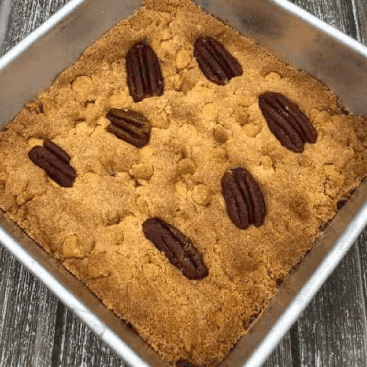 Folding flour and baking powder into blondie batter, adding butterscotch chips and pecans, spreading into pan, and air frying at 320°F for 12–15 minutes.