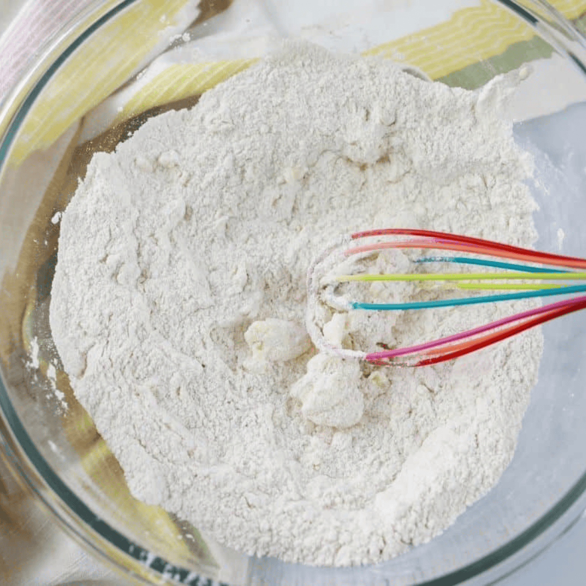 Mixing air fryer cinnamon sugar donut muffin batter in a large bowl
