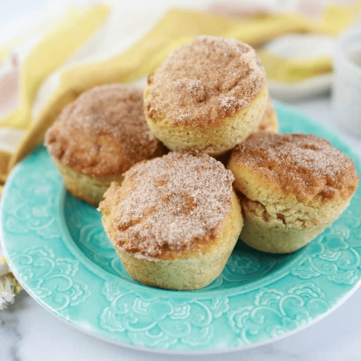 Golden air fryer cinnamon sugar donut muffins coated in sweet cinnamon-sugar topping