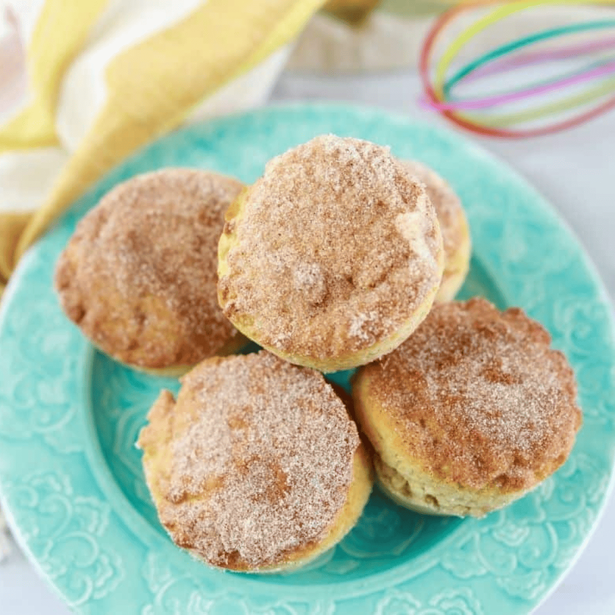 Golden air fryer cinnamon sugar donut muffins coated in cinnamon-sugar topping