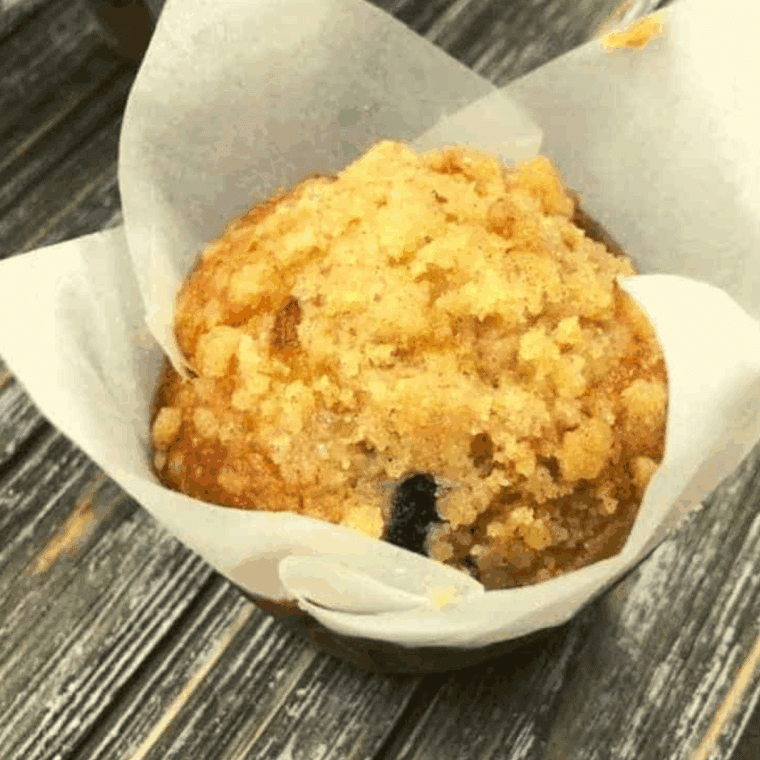 Golden, fluffy air fryer muffins bursting with wild blueberries, topped with a sweet crumb topping