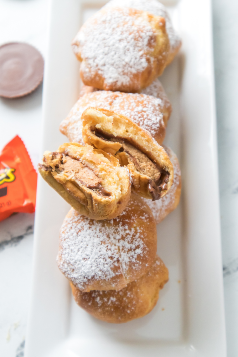 Air fryer Reese’s peanut butter cup bombs baked in dough until golden outside with melted chocolate and creamy peanut butter center ready in 8 minutes