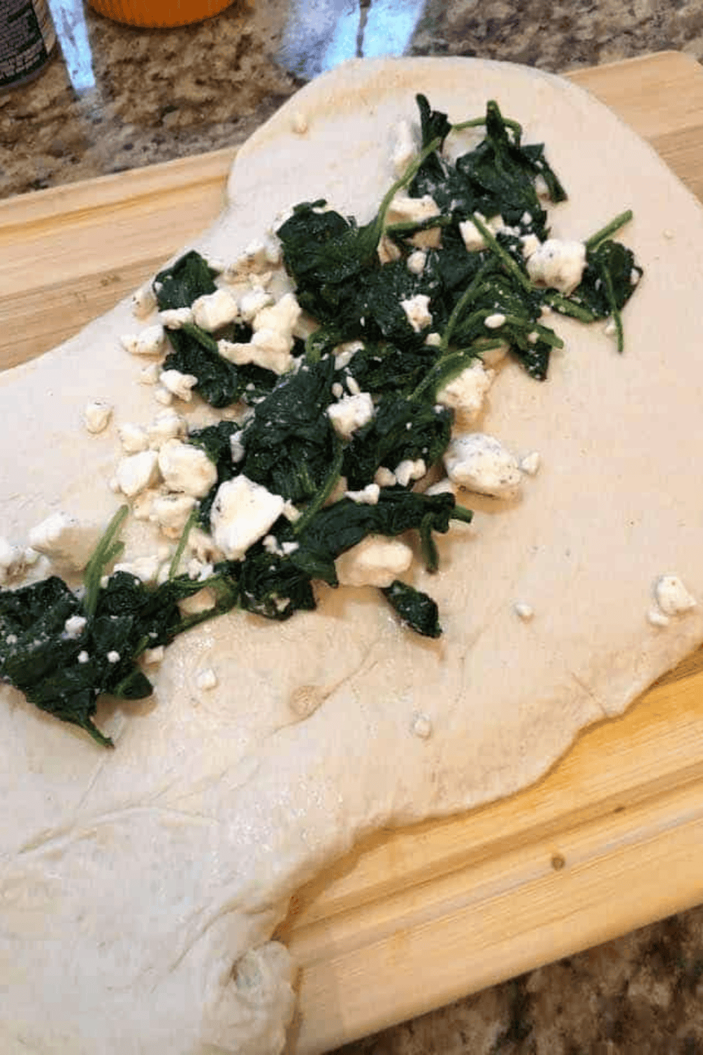 Spinach and feta stromboli cooking in the air fryer at 330°F, golden and crispy, with optional flipping halfway through.