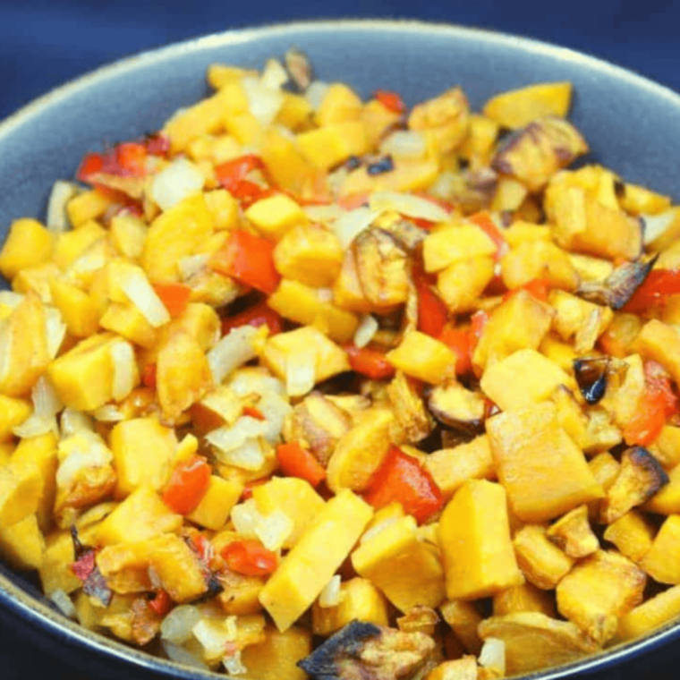 Air fryer sweet potato hash with crispy sweet potatoes bell peppers and onions in cast iron skillet