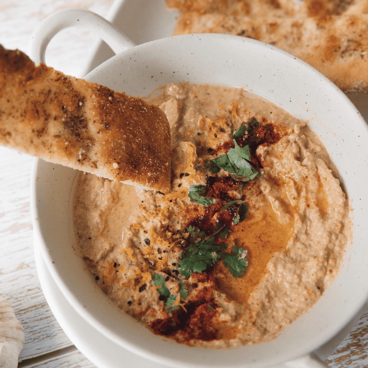 Crispy baked pita chips seasoned with olive oil and spices served as a crunchy Mediterranean snack for dipping