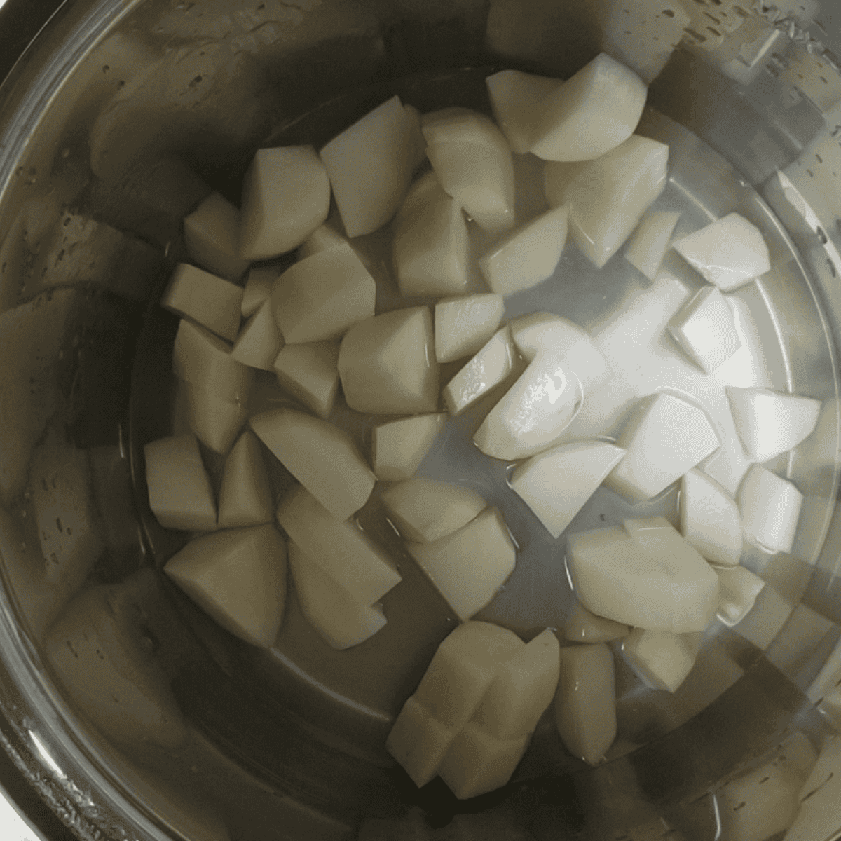 Placing potatoes in the Instant Pot, adding water and salt