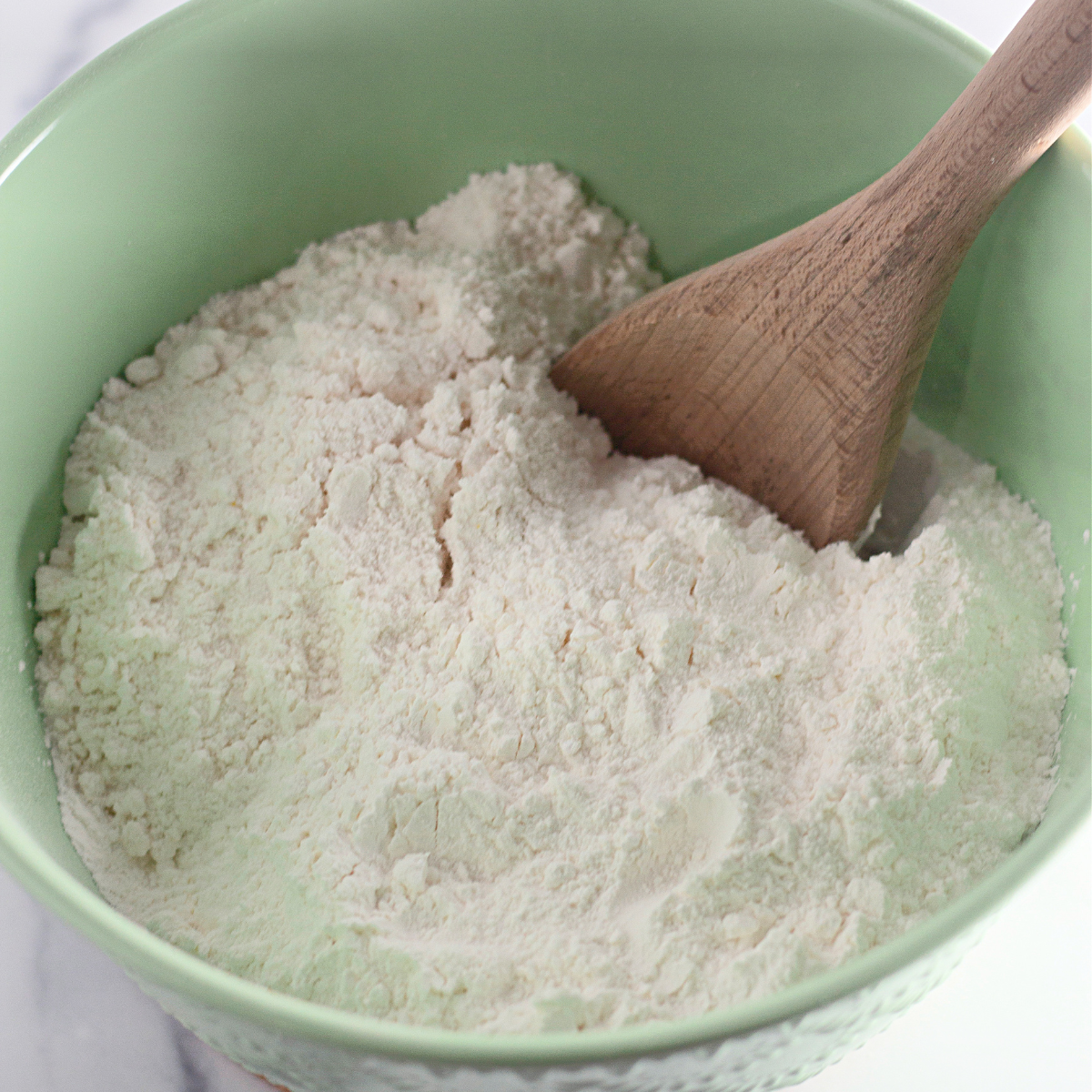 Ingredients for air fryer vanilla mug cake with icing measured into small bowls