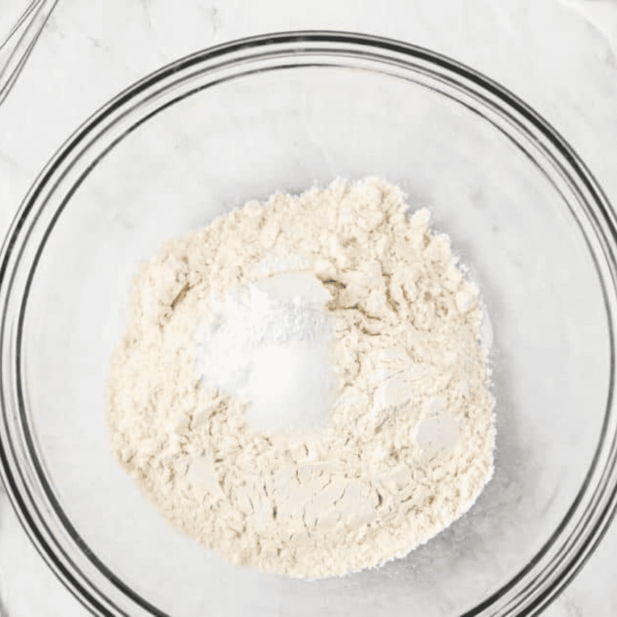 Whisking coffee cake batter in a large mixing bowl until smooth