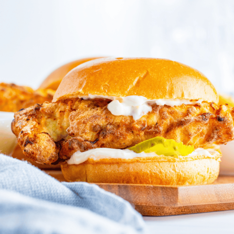 Air Fryer Popeyes Chicken Sandwich copycat with crispy fried chicken, pickles, and a toasted bun on a plate.