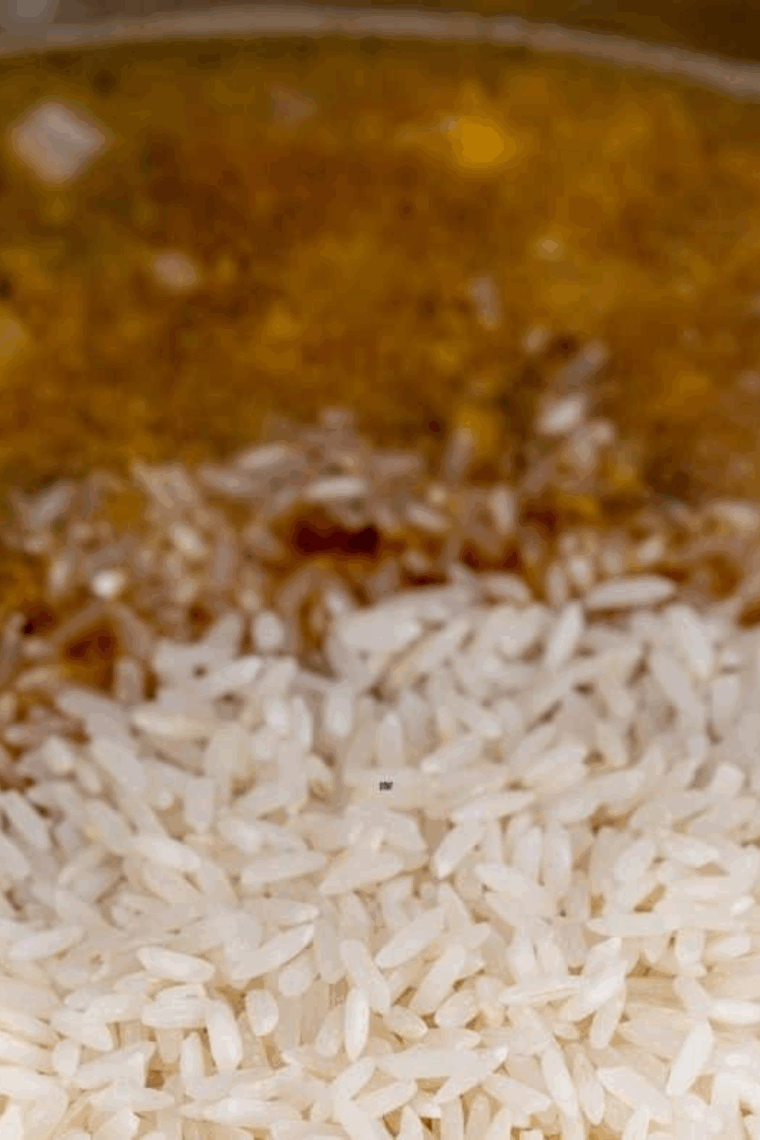 Adding rinsed rice, broth, and soy sauce to Instant Pot