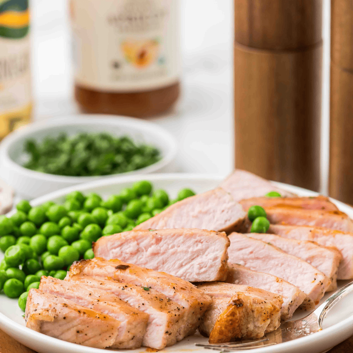 Air fryer frozen pork chops served juicy and golden on a white plate