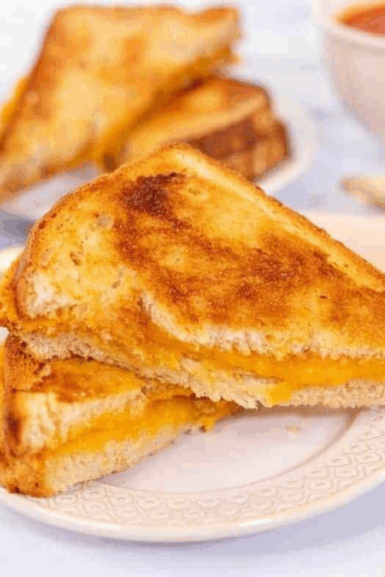 Golden brown air fryer grilled cheese sandwich with melted cheese inside