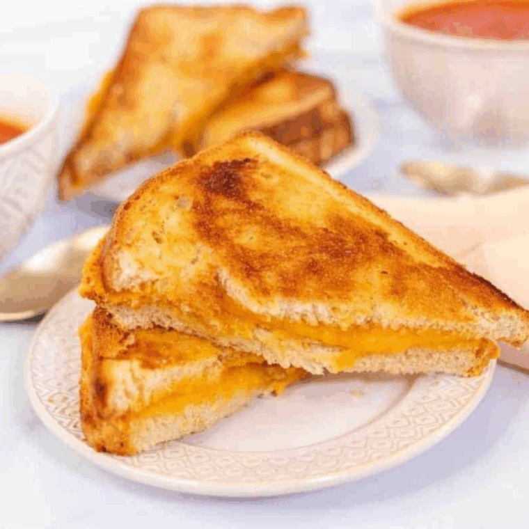 Sliced air fryer grilled cheese on a plate.