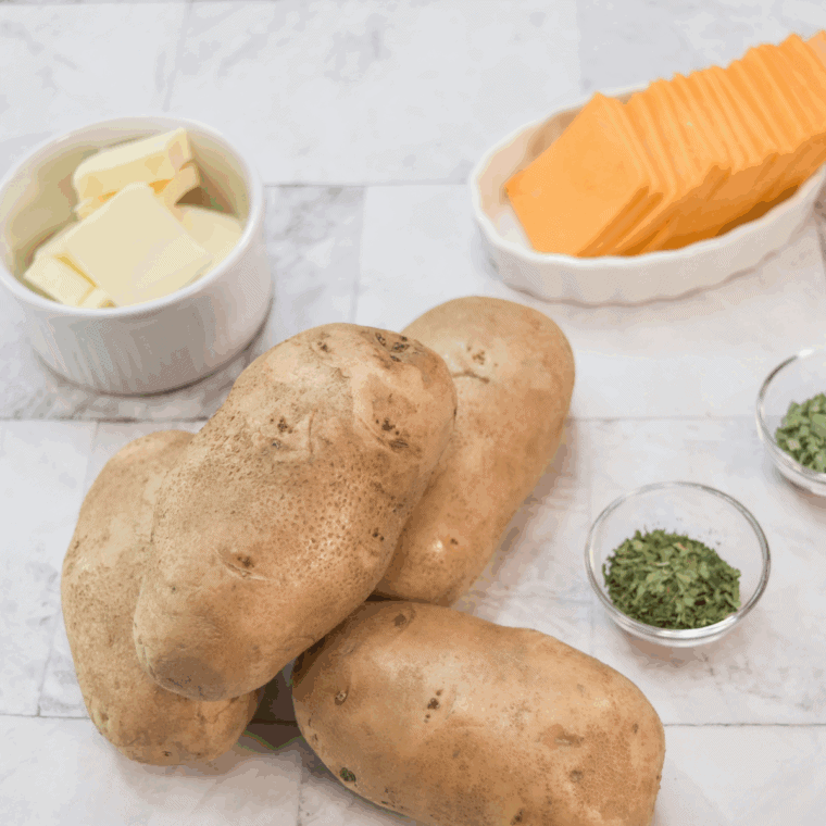Ingredients needed for Easy Air Fryer Cheesy Hasselback Potatoes on kitchen table.