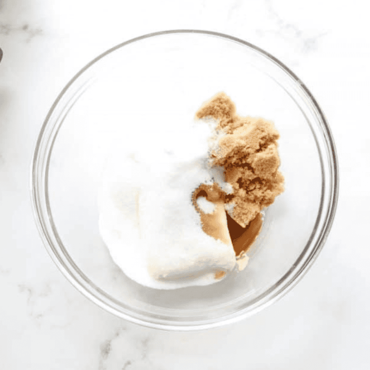 Small bowl with ingredients for caramel dip being mixed smooth with hand mixer