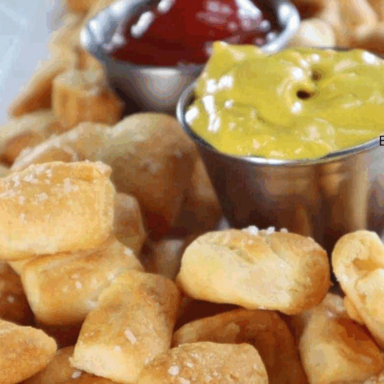 Small bowl of creamy Bojangles-style honey mustard sauce with a side of crispy chicken tenders