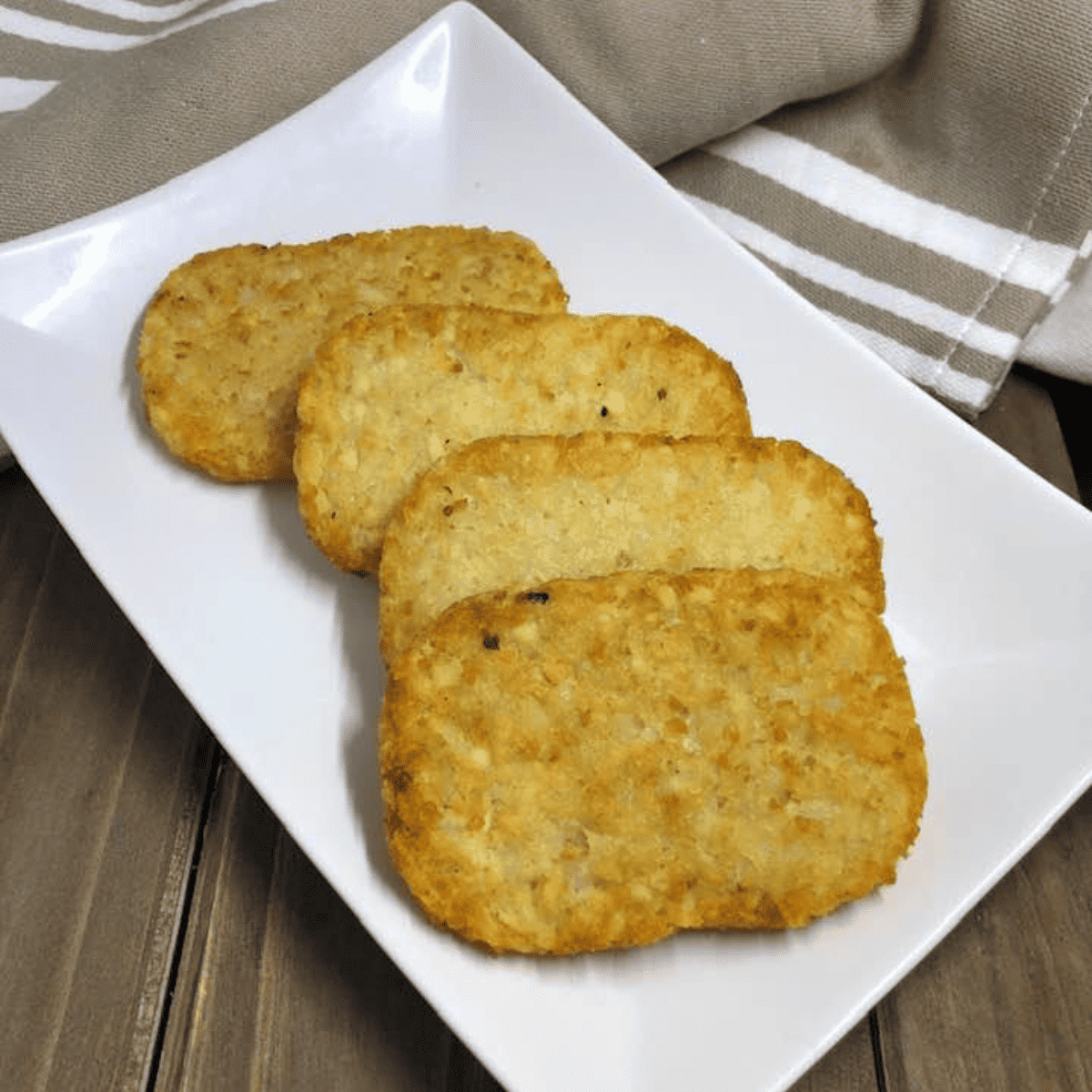 Frozen hash browns cooking in air fryer until golden brown and crispy in just 10 minutes for an easy breakfast side