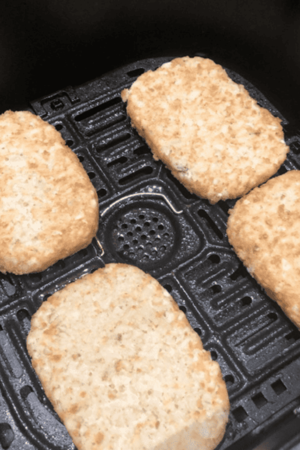 Preheating air fryer to 400°F before cooking frozen hash brown patties to ensure immediate crisping and golden texture instead of steaming