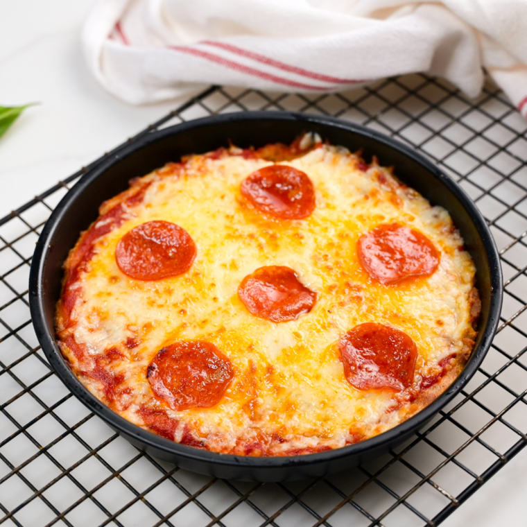 Finished 2 ingredient air fryer pizza with melted mozzarella and a crisp golden crust