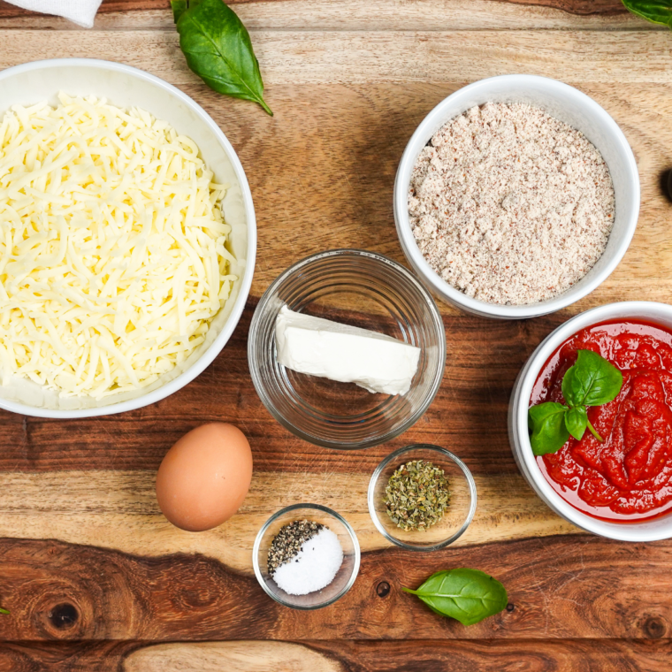 Ingredients for 2 ingredient air fryer pizza: Greek yogurt, self-rising flour, pizza sauce, and shredded mozzarella