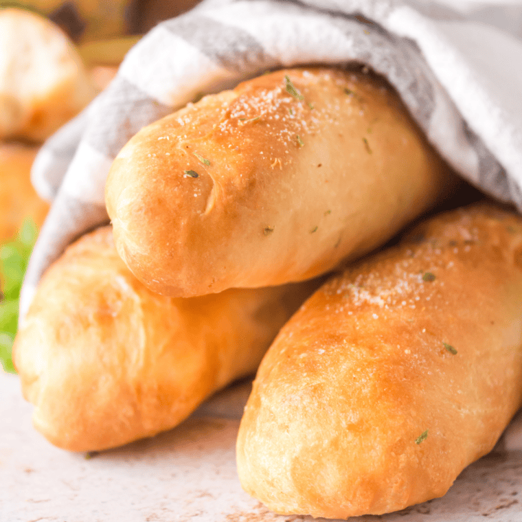 Plate of cooked air fryer breadsticks dusted with parmesan seasoning