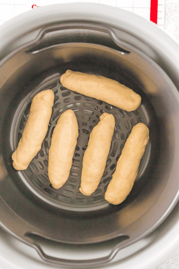 Twisted breadsticks brushed with melted butter in the air fryer basket