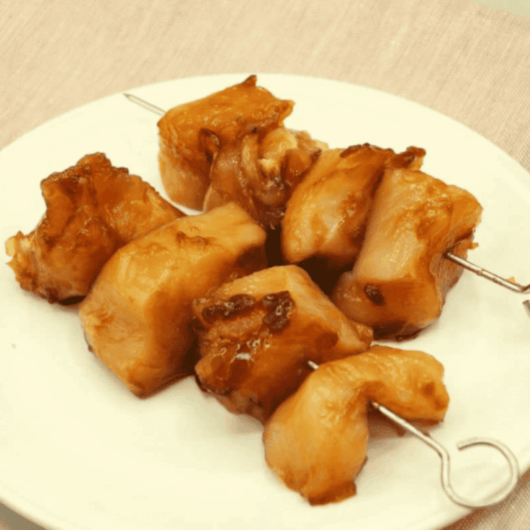Soak bamboo skewers to prevent burning, then thread marinated chicken, alternating with green onion pieces if desired, for air fryer yakitori.