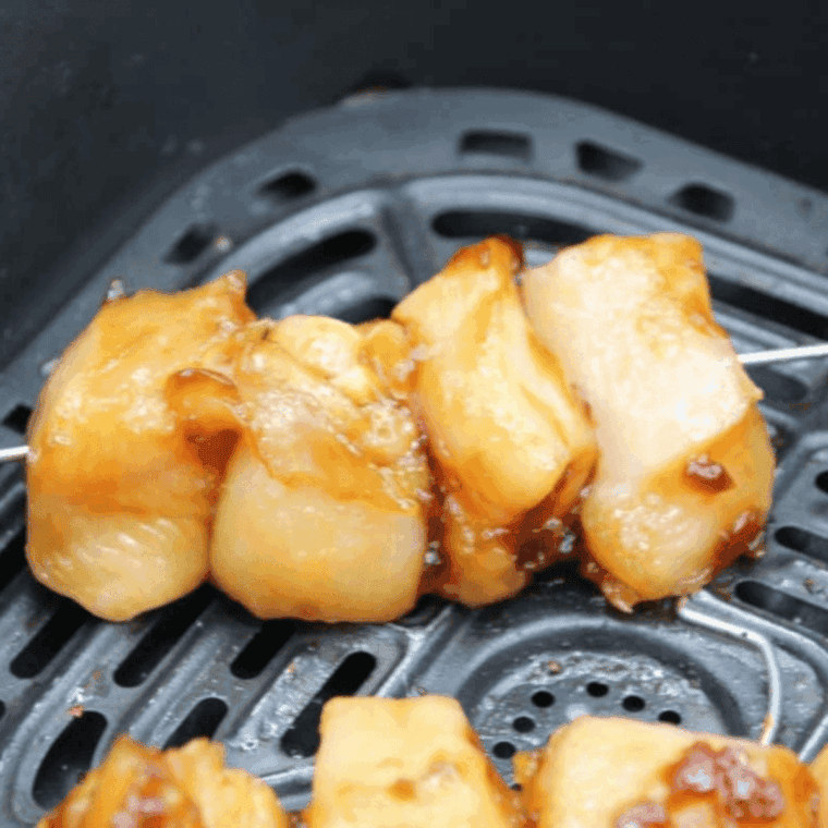 Preheat air fryer, place yakitori skewers in basket without overlapping, cook 10–12 minutes, turning halfway, optional higher heat for char.