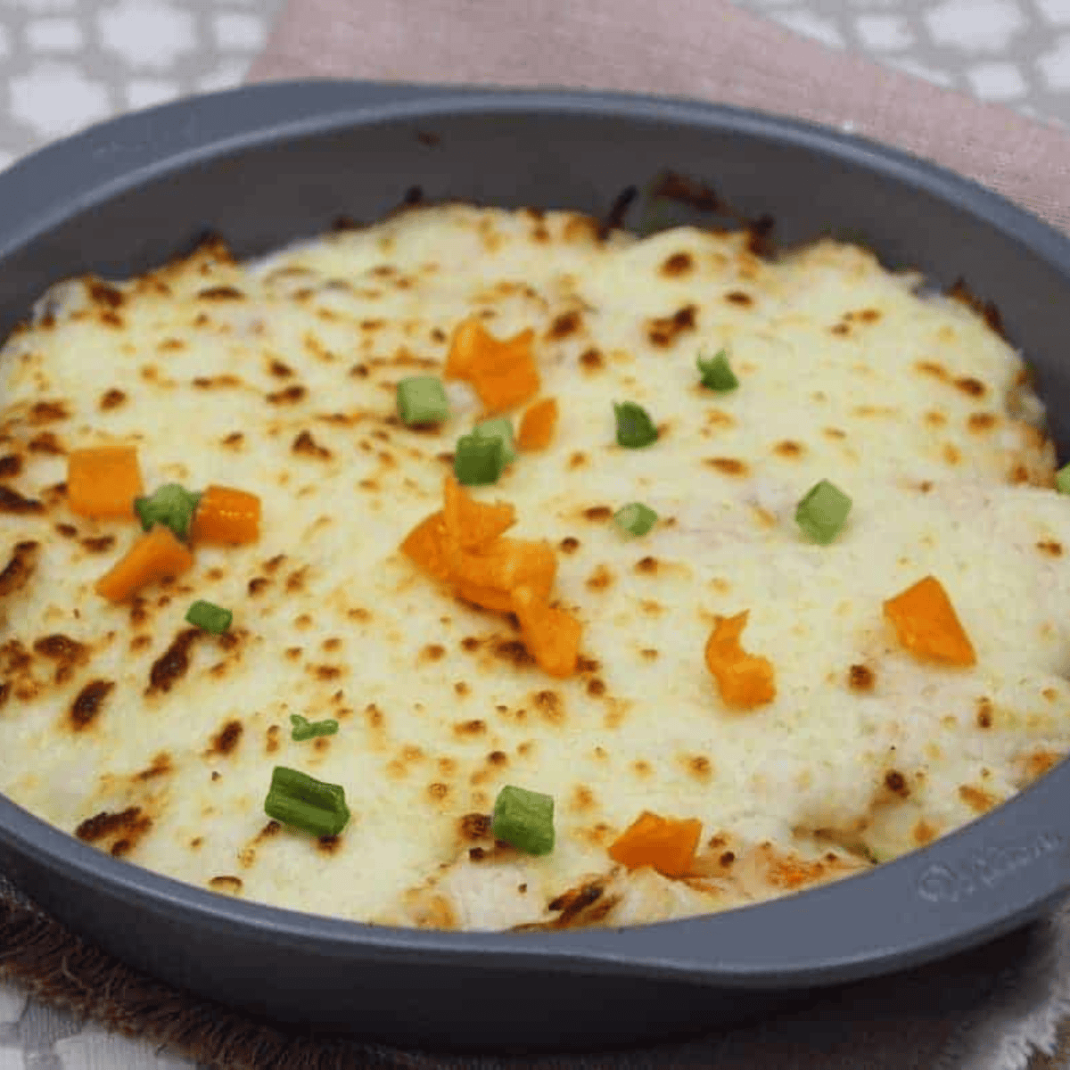 Air Fryer Chinese Buffet Crab Casserole – creamy crab casserole in a golden, bubbly topping, served in a white baking dish.
