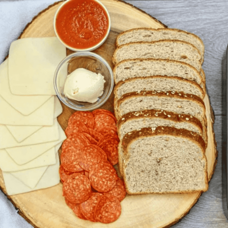 Ingredients for air fryer Italian grilled cheese sandwich: bread, provolone, Genoa salami, hard salami, prosciutto and butter