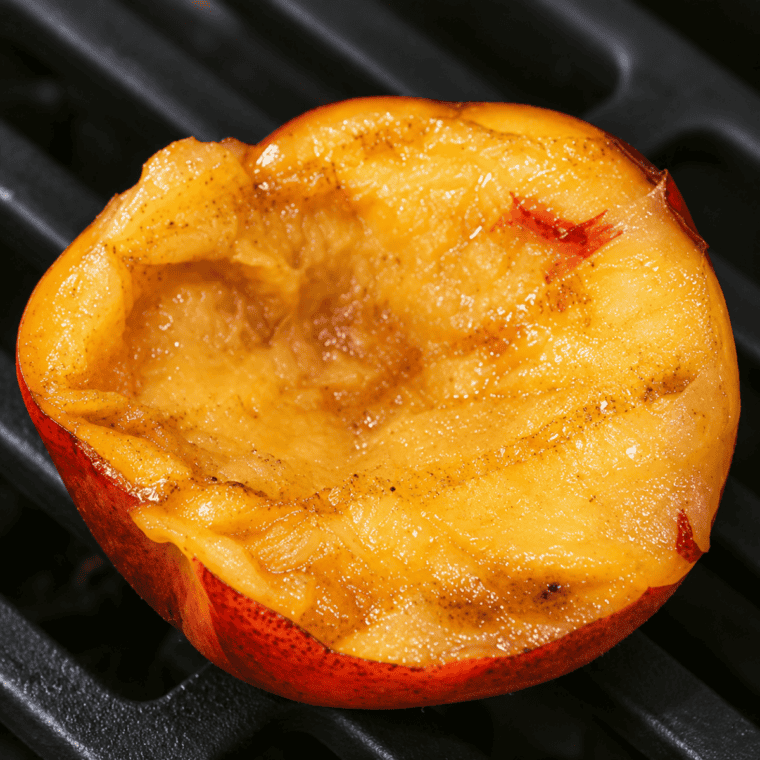 Halved nectarines brushed with melted butter and sprinkled with brown sugar and cinnamon before air frying.
