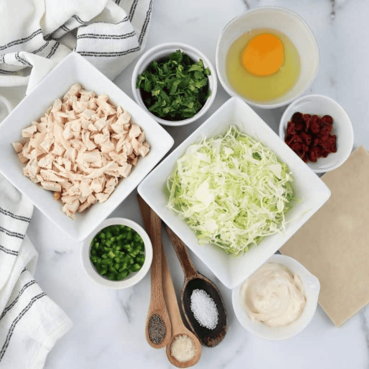 Ingredients needed for Air Fryer Pad Thai Chicken Egg Rolls on kitchen table.