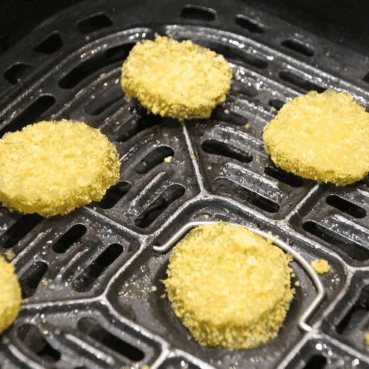 Place coated pickles in the air fryer basket.