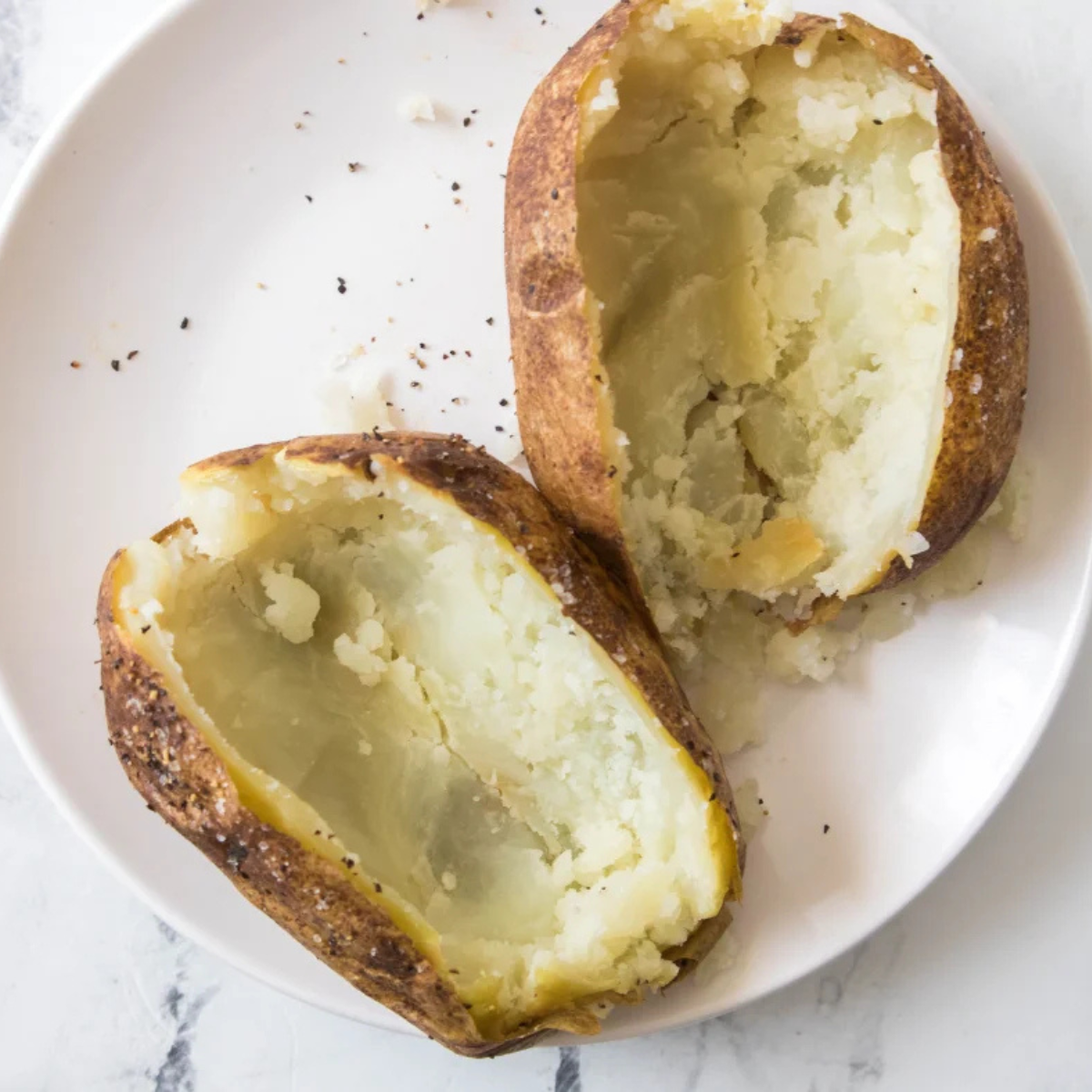 Baked potato halves with the flesh scooped out, leaving a quarter inch attached to the skin