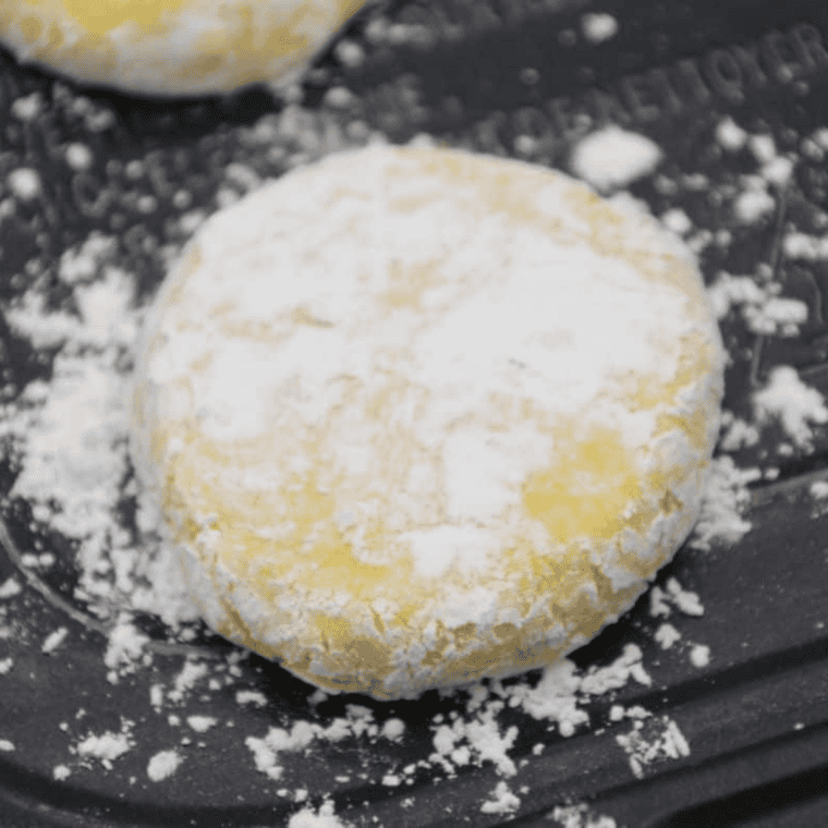 Lemon cookie dough placed in air fryer basket lined with parchment, cooking at 320°F.