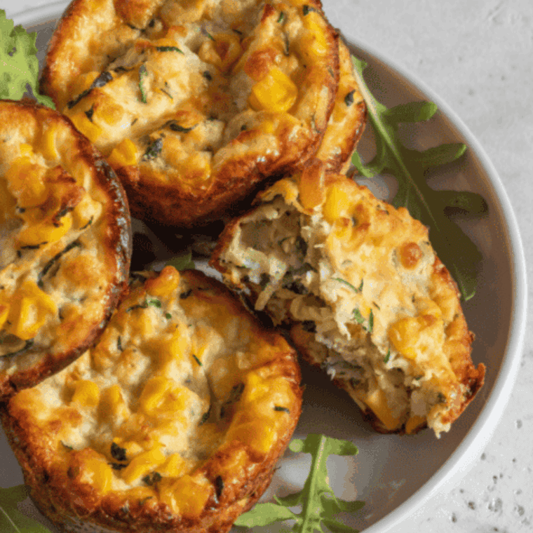 Golden, fluffy air fryer zucchini muffins with shredded zucchini and lightly sweetened centers