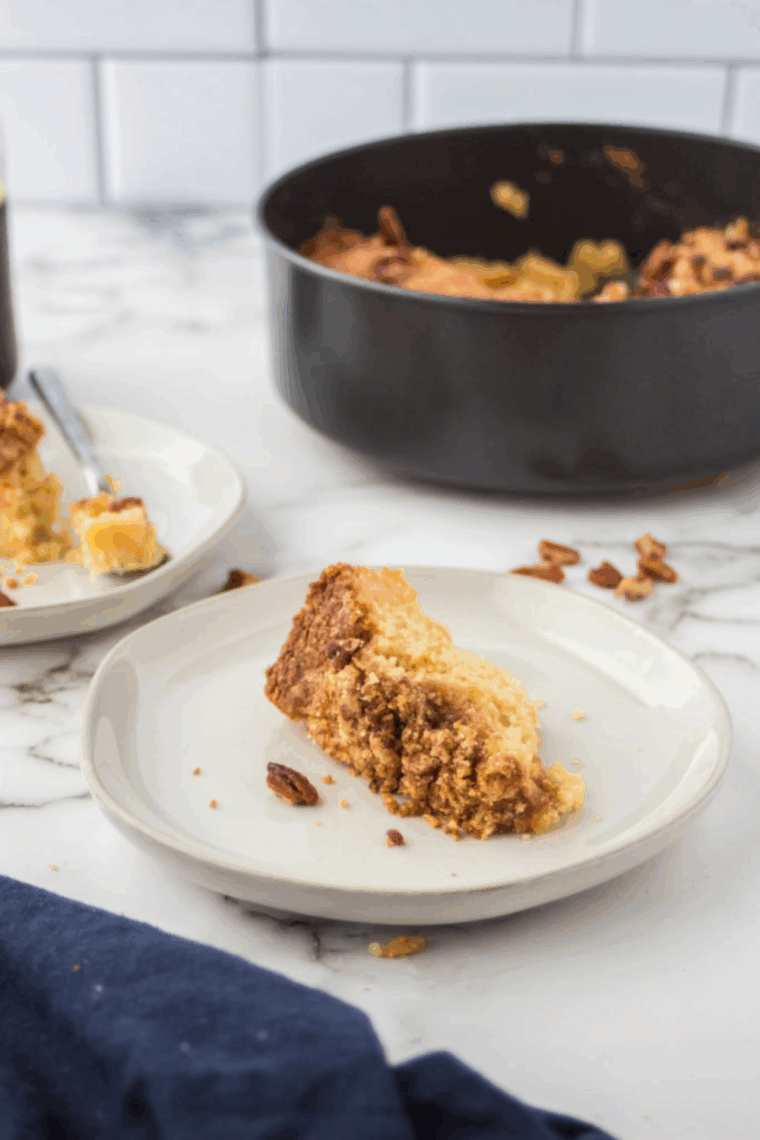 Ninja Foodi copycat Starbucks coffee cake with golden crumb topping, sliced and served on a plate.