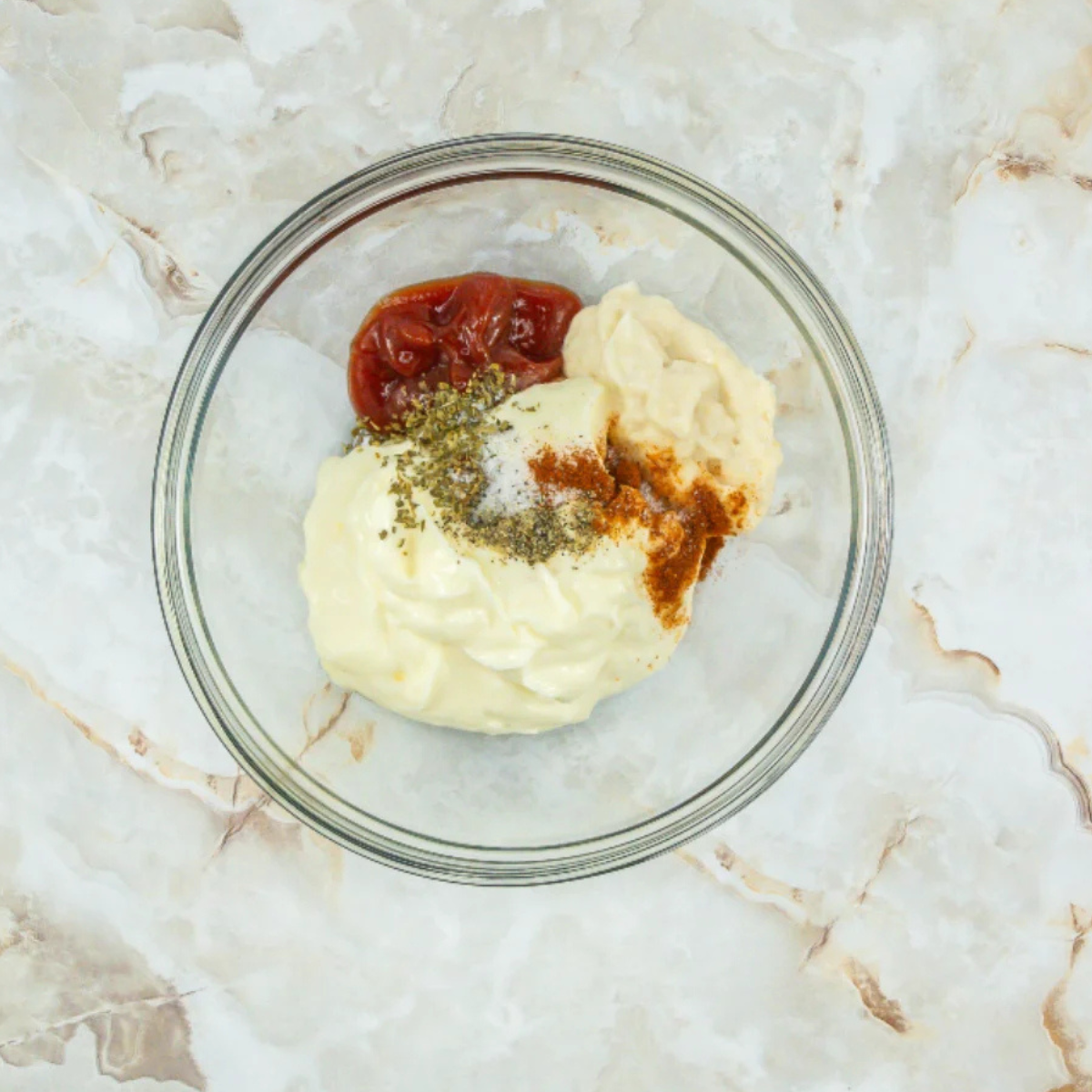 Mayonnaise, ketchup, horseradish, and spices added to a small mixing bowl to make bloomin' onion sauce