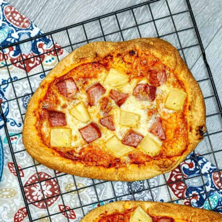 Air Fryer Hawaiian Pizza Flatbread topped with ham, pineapple, and melted cheese