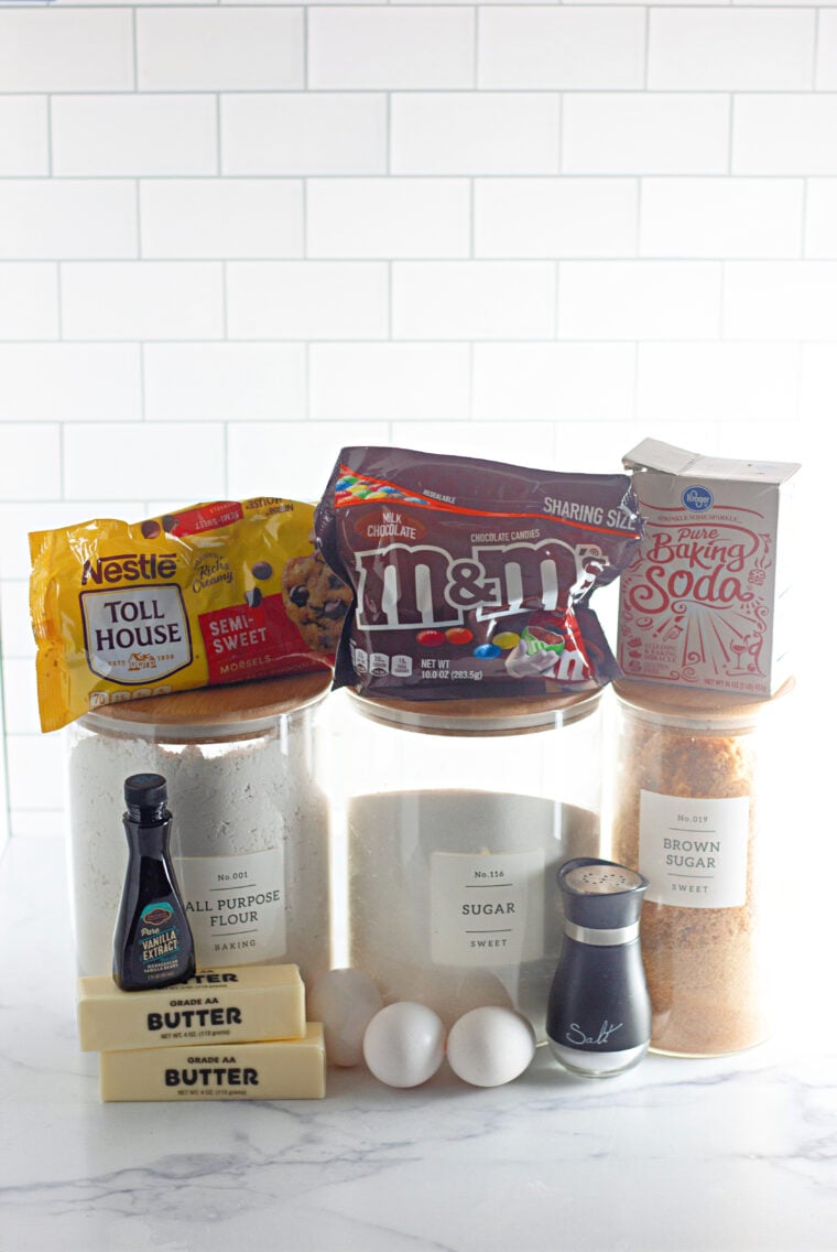 Ingredients for air fryer M&M mug cake: flour, sugar, butter, egg yolk, vanilla, and M&M candies