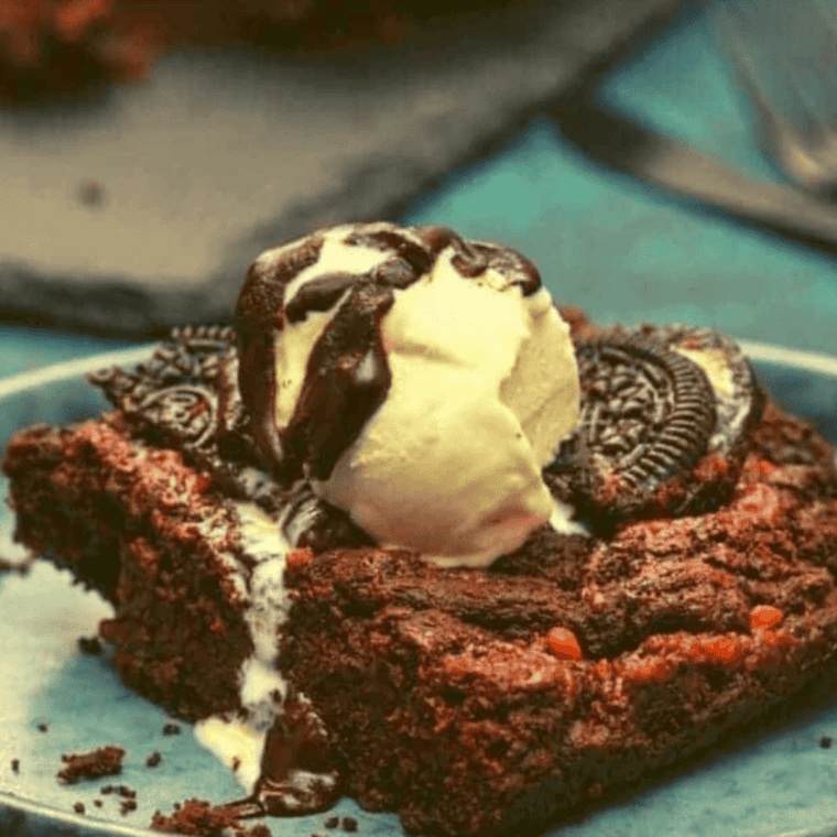 Fudgy air fryer Oreo brownies topped with crushed Oreo cookies served as rich chocolate dessert squares with gooey texture and cookie chunks