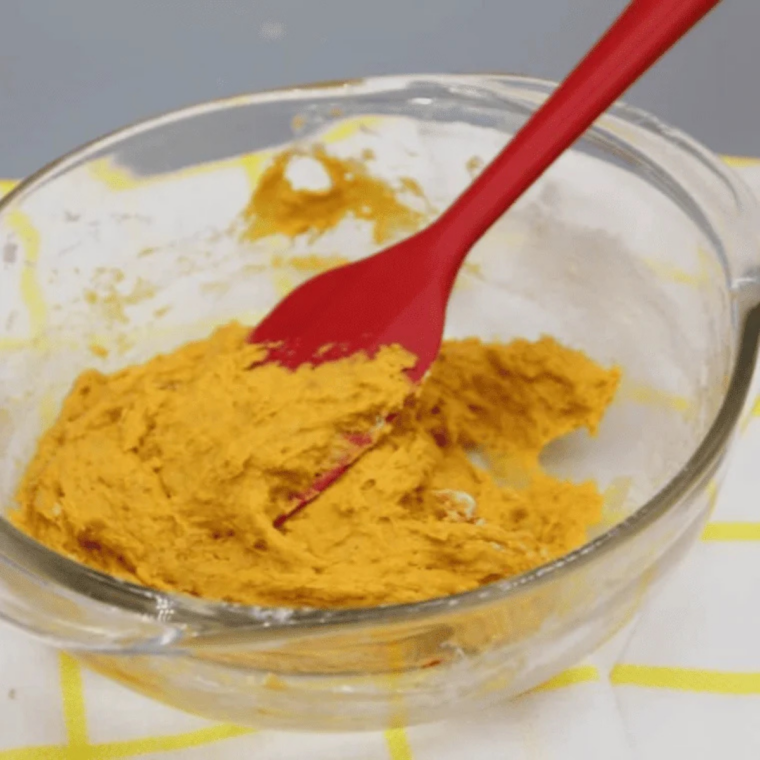 Flour, baking powder, and fall spices mixed into pumpkin coffee cake batter