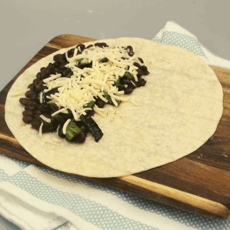 Tortilla filled with seasoned black beans, sautéed poblano peppers, and shredded cheese