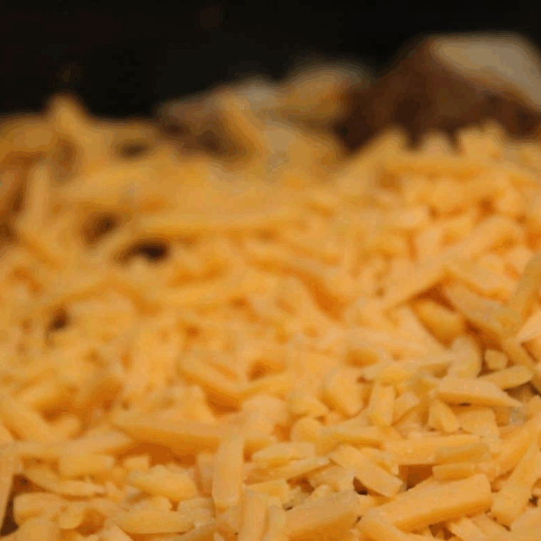 Potatoes air frying in Ninja Foodi at 370 degrees, stirred for even browning