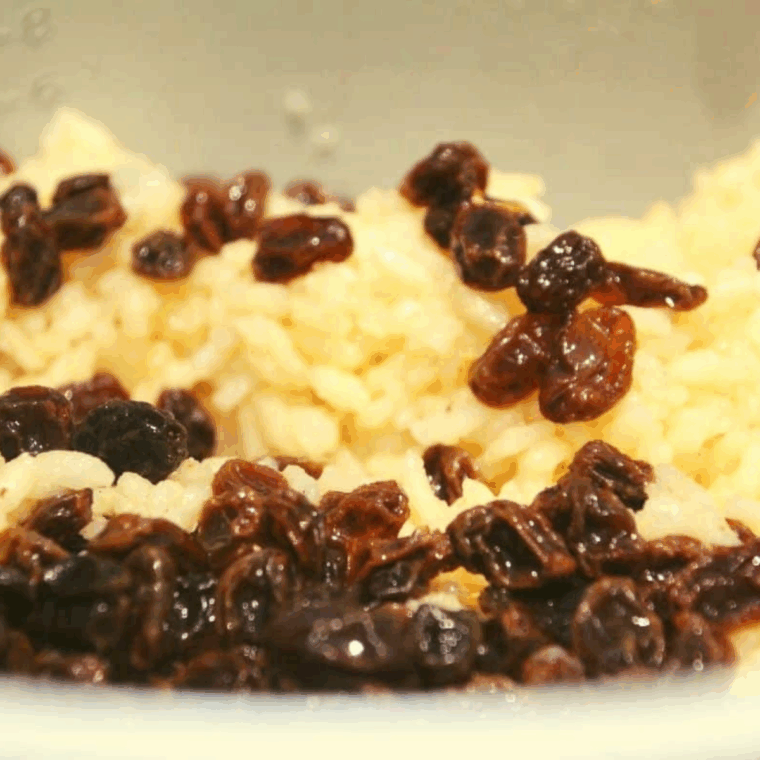 Golden, perfectly cooked rice pudding served in a white bowl with raisins and warm spices. This Ninja Foodi version is creamy, indulgent, and full of rum-infused flavor.