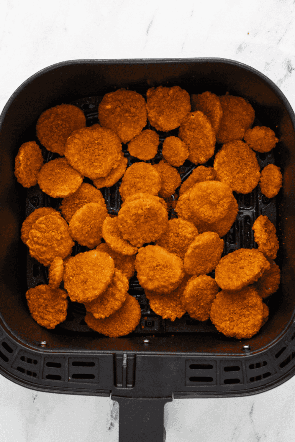 Place Frozen Fried Pickles in the air fryer basket.