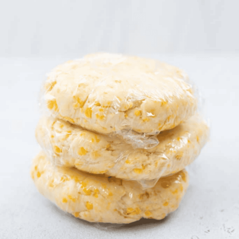 Homemade Cheez-It dough formed into a ball on a floured surface